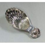 A silver caddy spoon with fluted bowl and shell th
