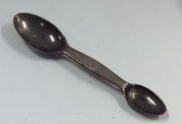 A novelty double ended silver medicine spoon with