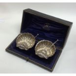 A boxed pair of silver butter shells together with