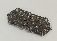 An Edwardian silver embossed nurse's buckle attrac