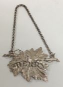 A Victorian silver Sherry label with leaf decorati