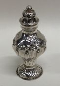 A novelty silver pepper with chased decoration. Ap