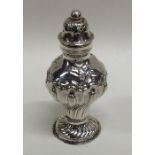 A novelty silver pepper with chased decoration. Ap