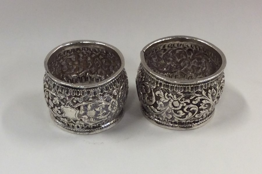 A pair of heavy Indian silver napkin rings decorat