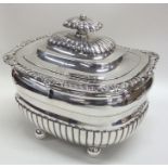 A Georgian silver half fluted tea caddy on ball fe