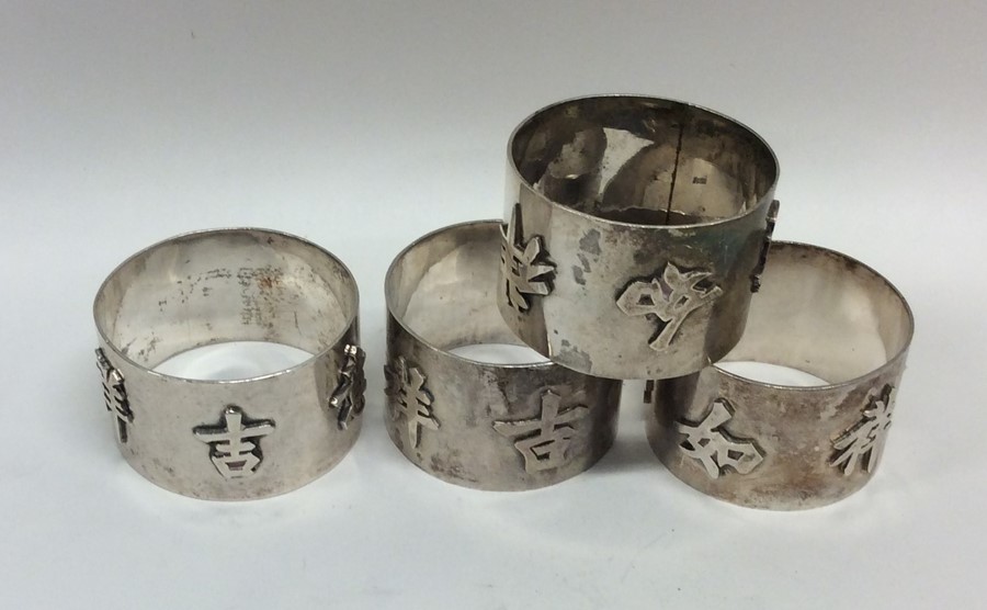 A heavy set of four Chinese silver napkin rings. A