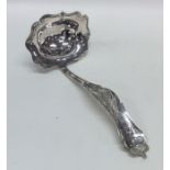A Dutch silver sifter spoon attractively decorated