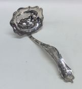 A Dutch silver sifter spoon attractively decorated