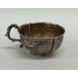 A Russian silver gilt cup decorated with scrolls a