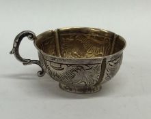 A Russian silver gilt cup decorated with scrolls a