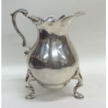 A good heavy George II silver cream jug with squat
