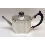 A Georgian silver bright cut teapot with ebony han