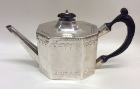 A Georgian silver bright cut teapot with ebony han