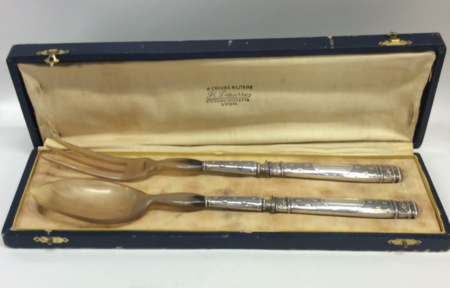 A cased pair of Continental silver salad servers.