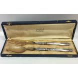 A cased pair of Continental silver salad servers.