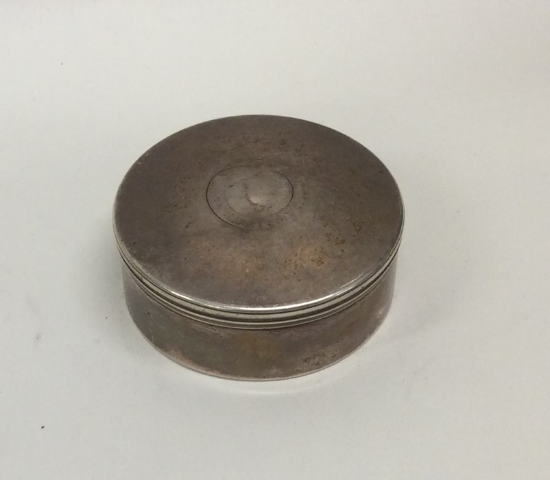 A circular silver pill box with hinged cover. Lond