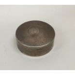A circular silver pill box with hinged cover. Lond