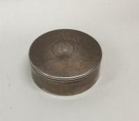 A circular silver pill box with hinged cover. Lond