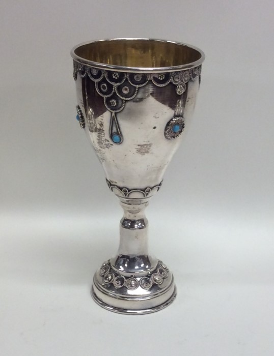 An Eastern silver cup attractively decorated with