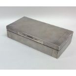 An Art Deco engine turned silver cigarette box wit
