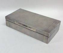 An Art Deco engine turned silver cigarette box wit