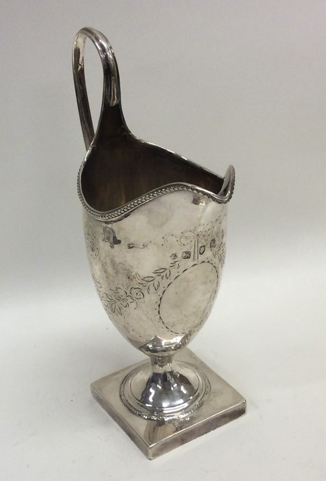 A Georgian Adams' style cream jug on square base w