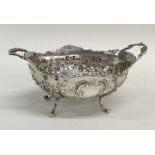 A silver two handled bonbon dish decorated with fl