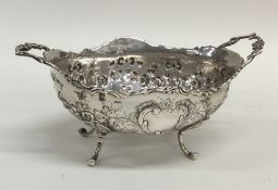 A silver two handled bonbon dish decorated with fl