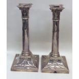 A pair of silver candlesticks on spreading base de