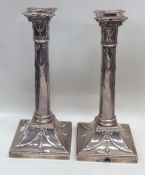 A pair of silver candlesticks on spreading base de