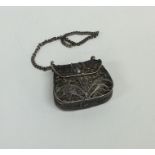 A silver filigree mounted purse with hinged loop t
