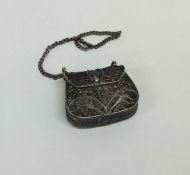 A silver filigree mounted purse with hinged loop t