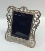 An attractive silver pierced picture frame decorat