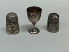 Two silver thimbles together with a miniature silv