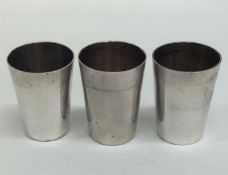 A set of three Russian silver vodka tots of taperi