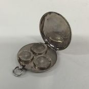 An unusual circular silver sovereign case with loo