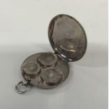 An unusual circular silver sovereign case with loo