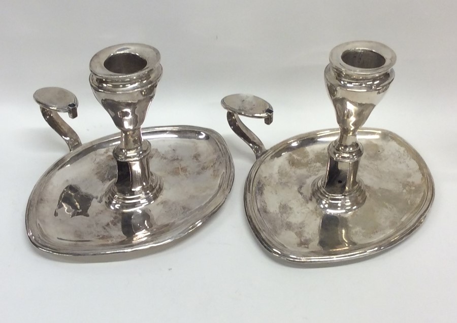 A pair of Georgian silver oval chamber sticks with