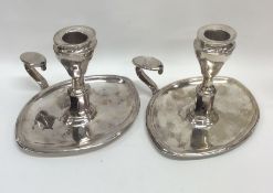 A pair of Georgian silver oval chamber sticks with