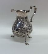 A good Georgian silver helmet shaped cream jug emb