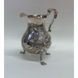 A good Georgian silver helmet shaped cream jug emb