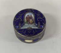 A Continental silver and enamel pill box decorated