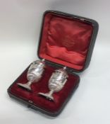 A pair of cased silver campana shaped pepperettes.