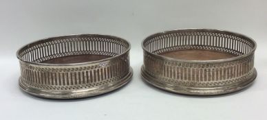 A pair of Edwardian silver wine coasters with pier