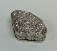 A shaped front Indian silver box decorated with fl