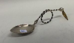 A Continental silver caddy spoon with swirl decora