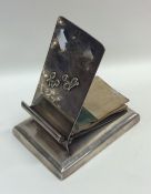 A heavy silver clip mounted with a notepad. London