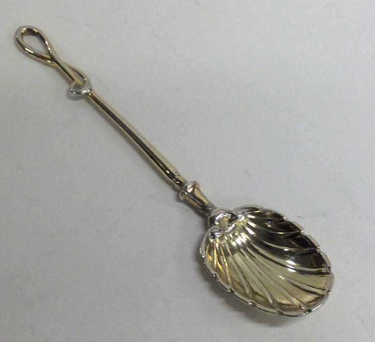 An unusual silver gilt spoon in the form of a whip