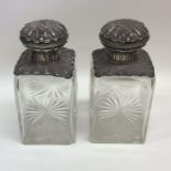 A pair of rectangular hinged top scent bottles emb