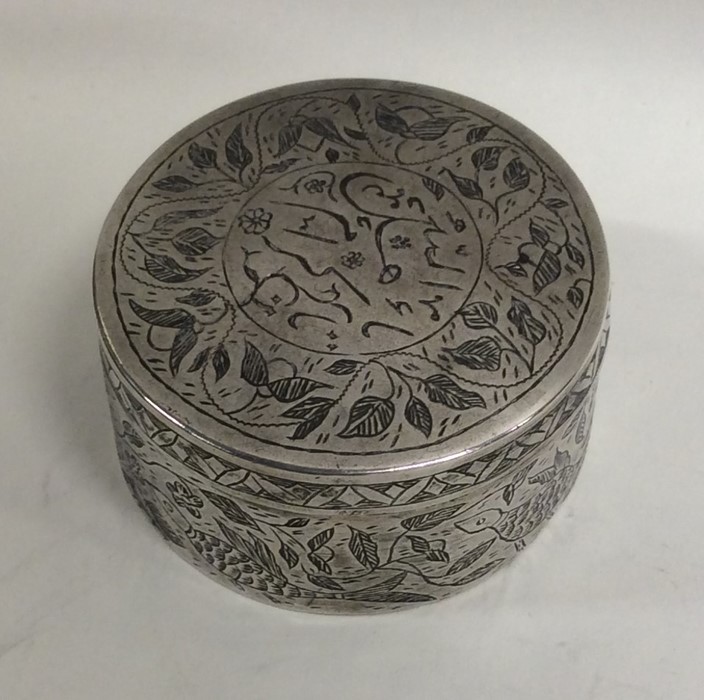 A circular Islamic pill box attractively decorated